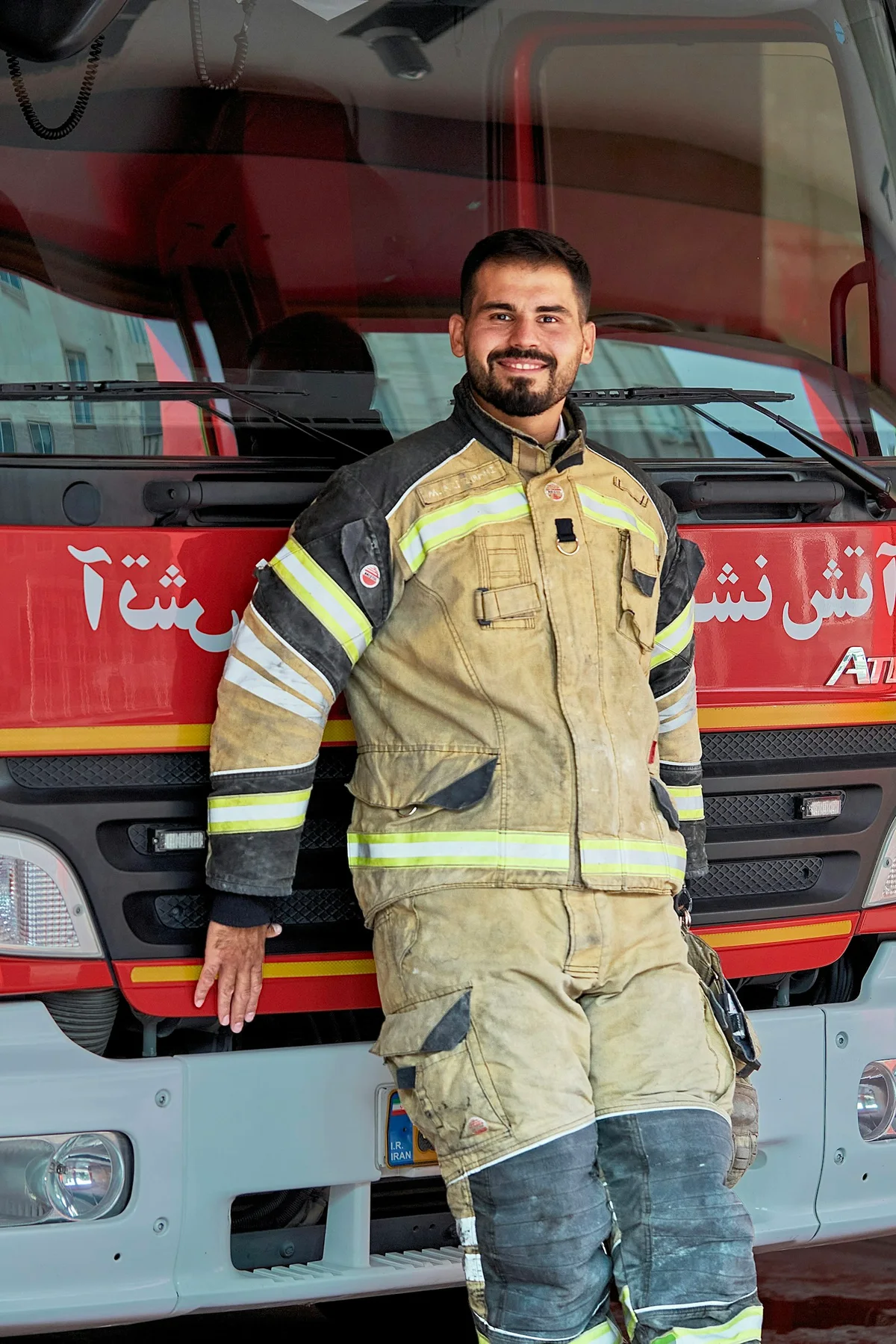 A firefighter beside a fire truck