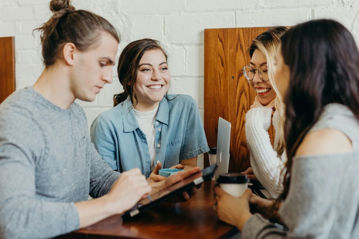 People talking together around a table.