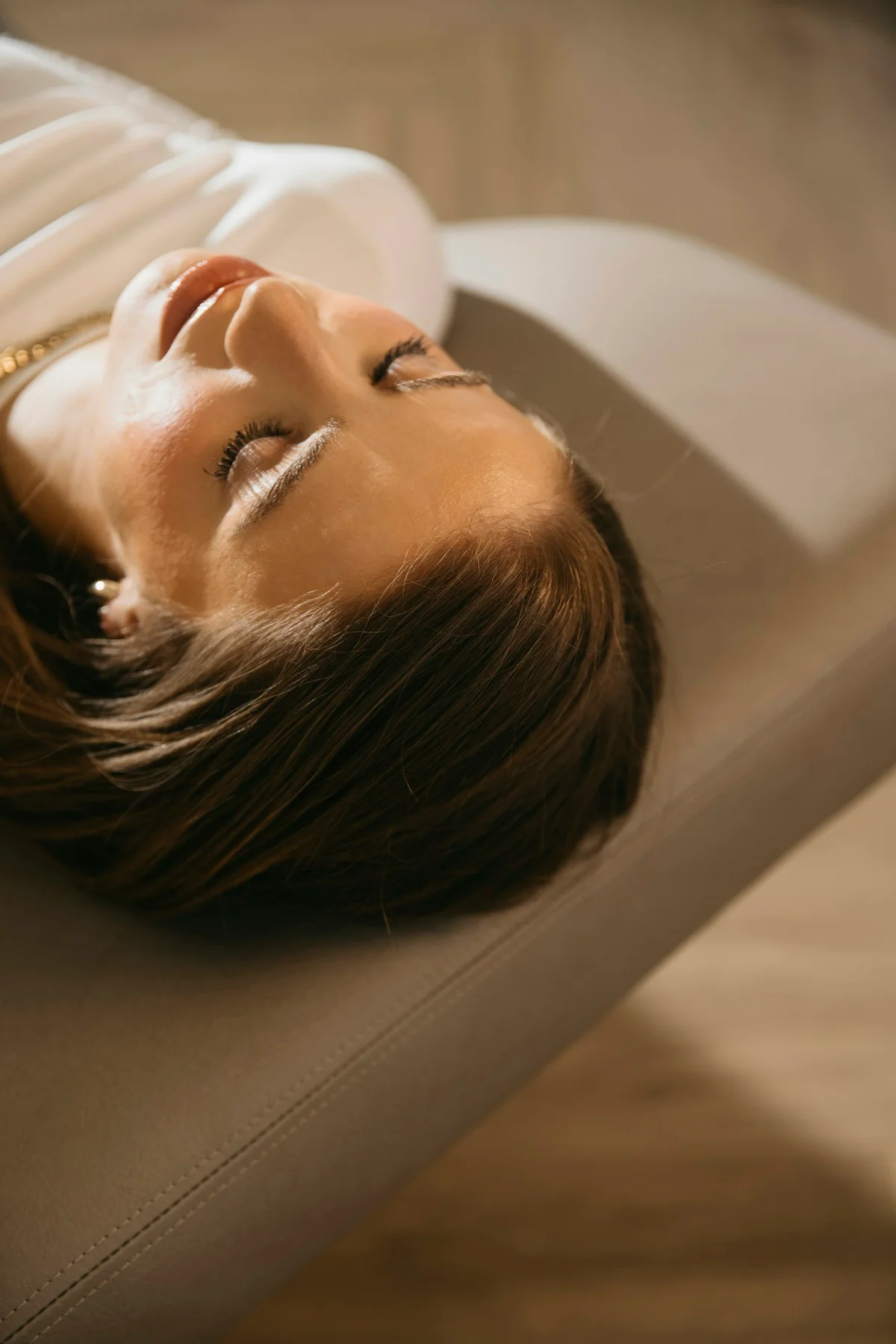 A woman resting on a sofa.