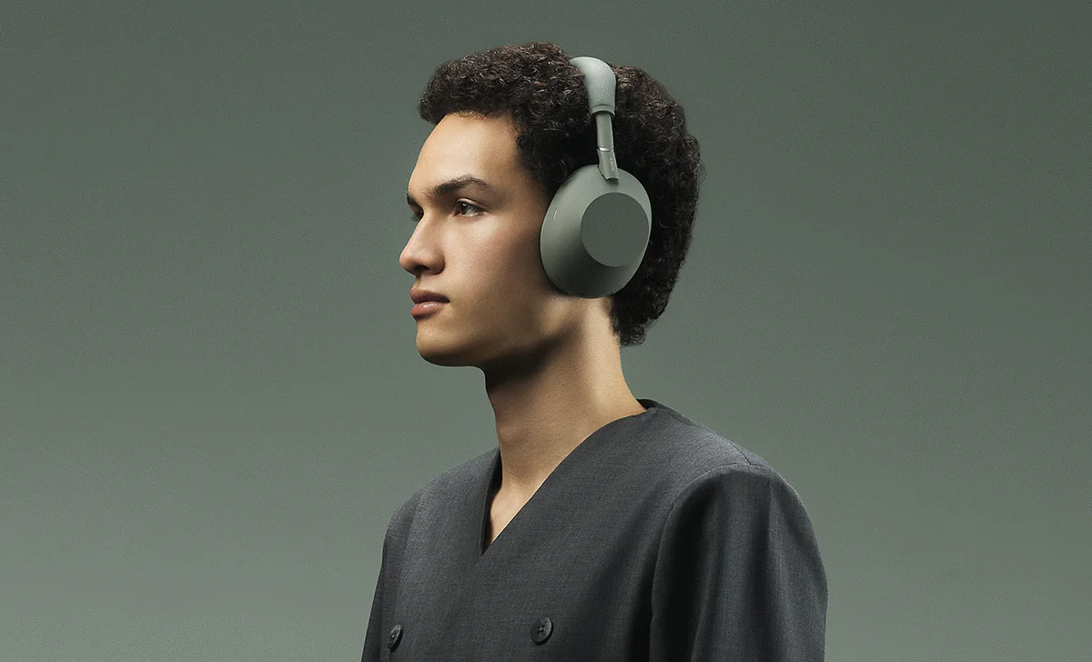 A person wearing Sony WH-1000XM6 headphones